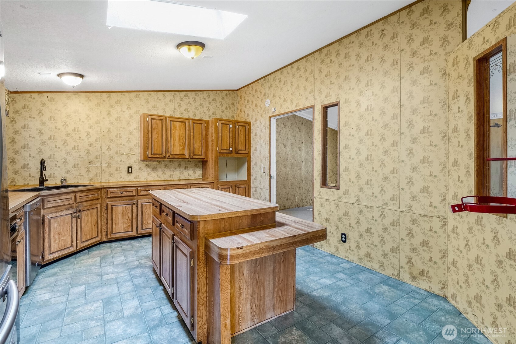 8674 Vince Road Northeast Moses Lake, WA 98837 - Photo 16 of 39 a kitchen with a stove a sink and a refrigerator