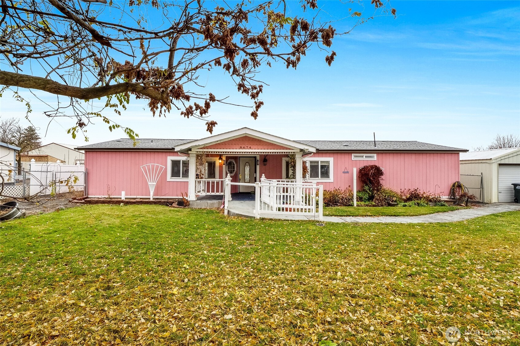 8674 Vince Road Northeast Moses Lake, WA 98837 - Photo 2 of 39 a front view of a house with garden