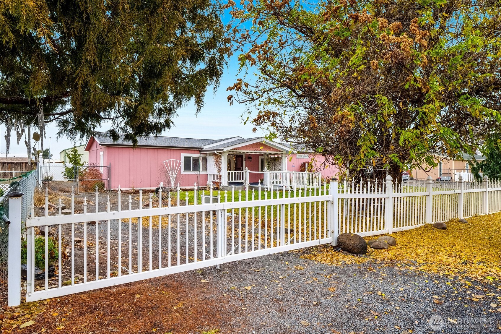 8674 Vince Road Northeast Moses Lake, WA 98837 - Photo 3 of 39 a view of a house with a small yard and a large tree