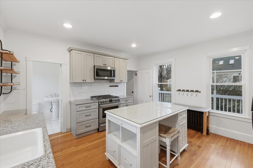163 West Central Street Franklin, MA 02038 - Photo 11 of 39 a kitchen with a stove a sink and a refrigerator