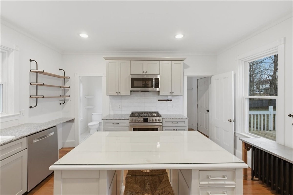 163 West Central Street Franklin, MA 02038 - Photo 13 of 39 a kitchen with a stove a sink and a refrigerator
