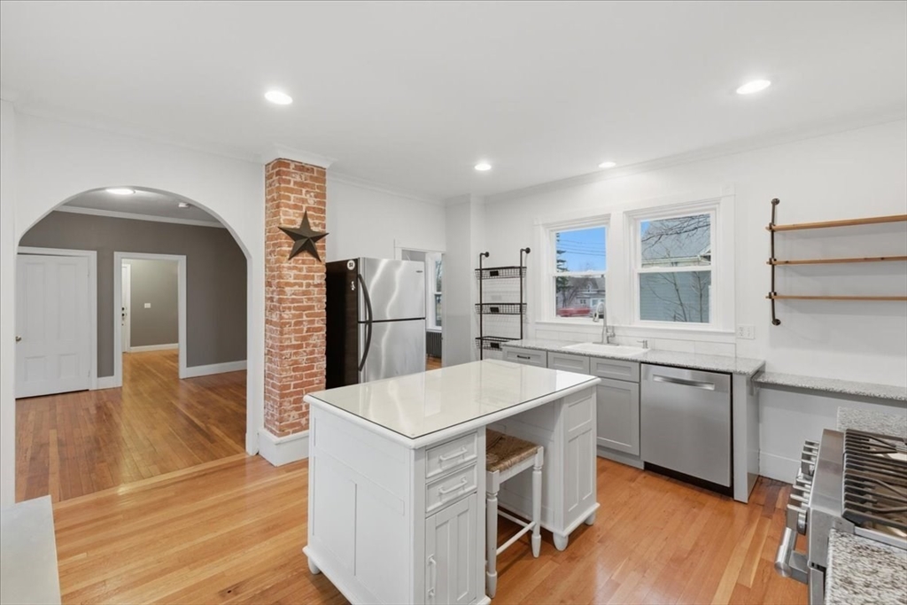 163 West Central Street Franklin, MA 02038 - Photo 14 of 39 a kitchen with stainless steel appliances granite countertop a sink stove and refrigerator