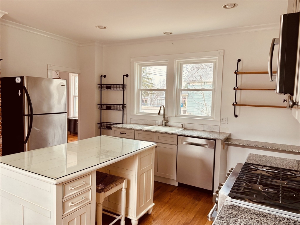 163 West Central Street Franklin, MA 02038 - Photo 15 of 39 a kitchen with stainless steel appliances granite countertop a sink stove and refrigerator