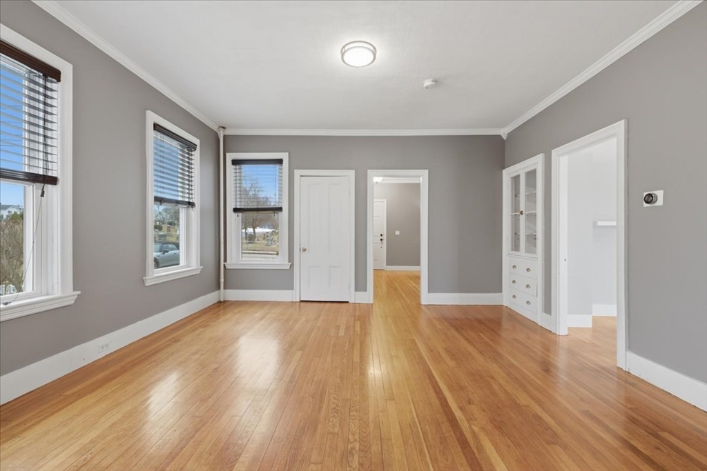 163 West Central Street Franklin, MA 02038 - Photo 18 of 39 a view of an empty room with window and wooden floor