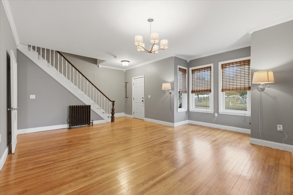 163 West Central Street Franklin, MA 02038 - Photo 20 of 39 a view of an empty room with wooden floor and a window