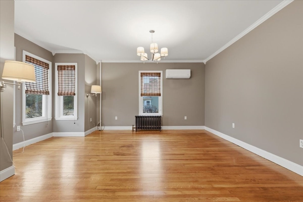 163 West Central Street Franklin, MA 02038 - Photo 22 of 39 a view of an empty room with window and wooden floor
