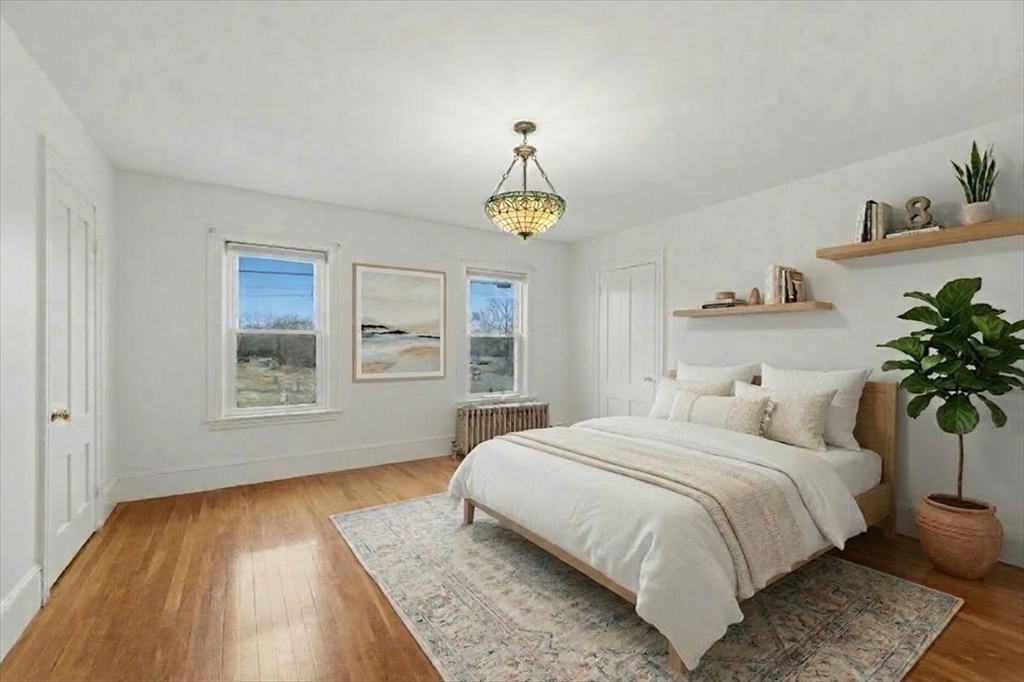163 West Central Street Franklin, MA 02038 - Photo 27 of 39 a bedroom with a bed and a window