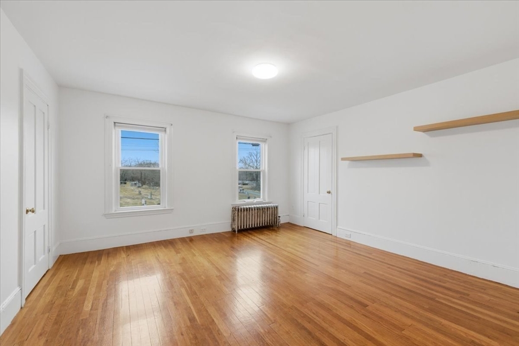 163 West Central Street Franklin, MA 02038 - Photo 28 of 39 a view of an empty room with wooden floor and a window