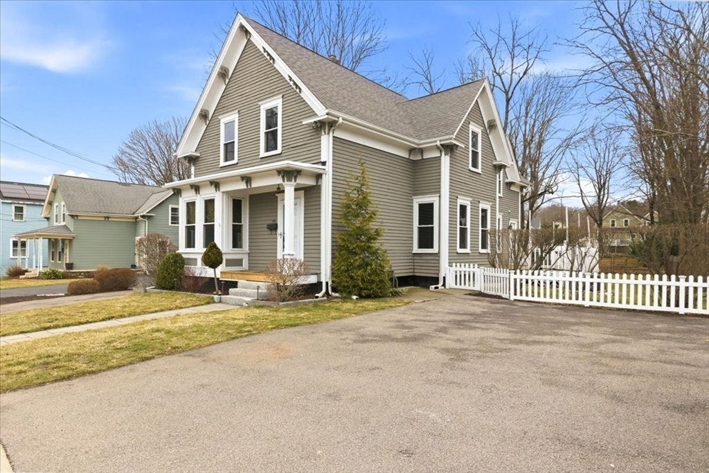 163 West Central Street Franklin, MA 02038 - Photo 3 of 39 a view of a white house with a large windows and a large tree