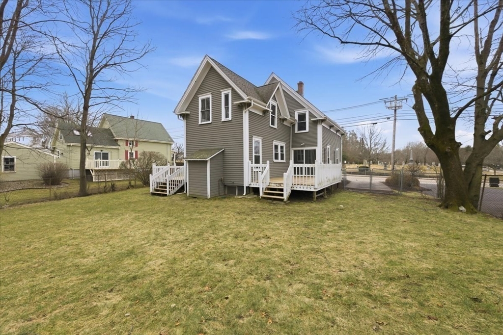 163 West Central Street Franklin, MA 02038 - Photo 4 of 39 a view of a large house with a large tree and a yard
