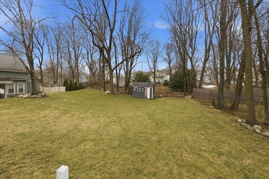 163 West Central Street Franklin, MA 02038 - Photo 8 of 39 a backyard of a house with lots of green space
