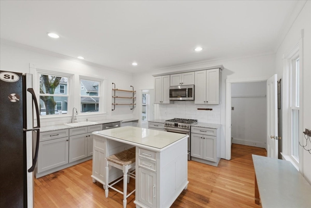 163 West Central Street Franklin, MA 02038 - Photo 10 of 39 a kitchen with stainless steel appliances granite countertop a refrigerator stove microwave and sink