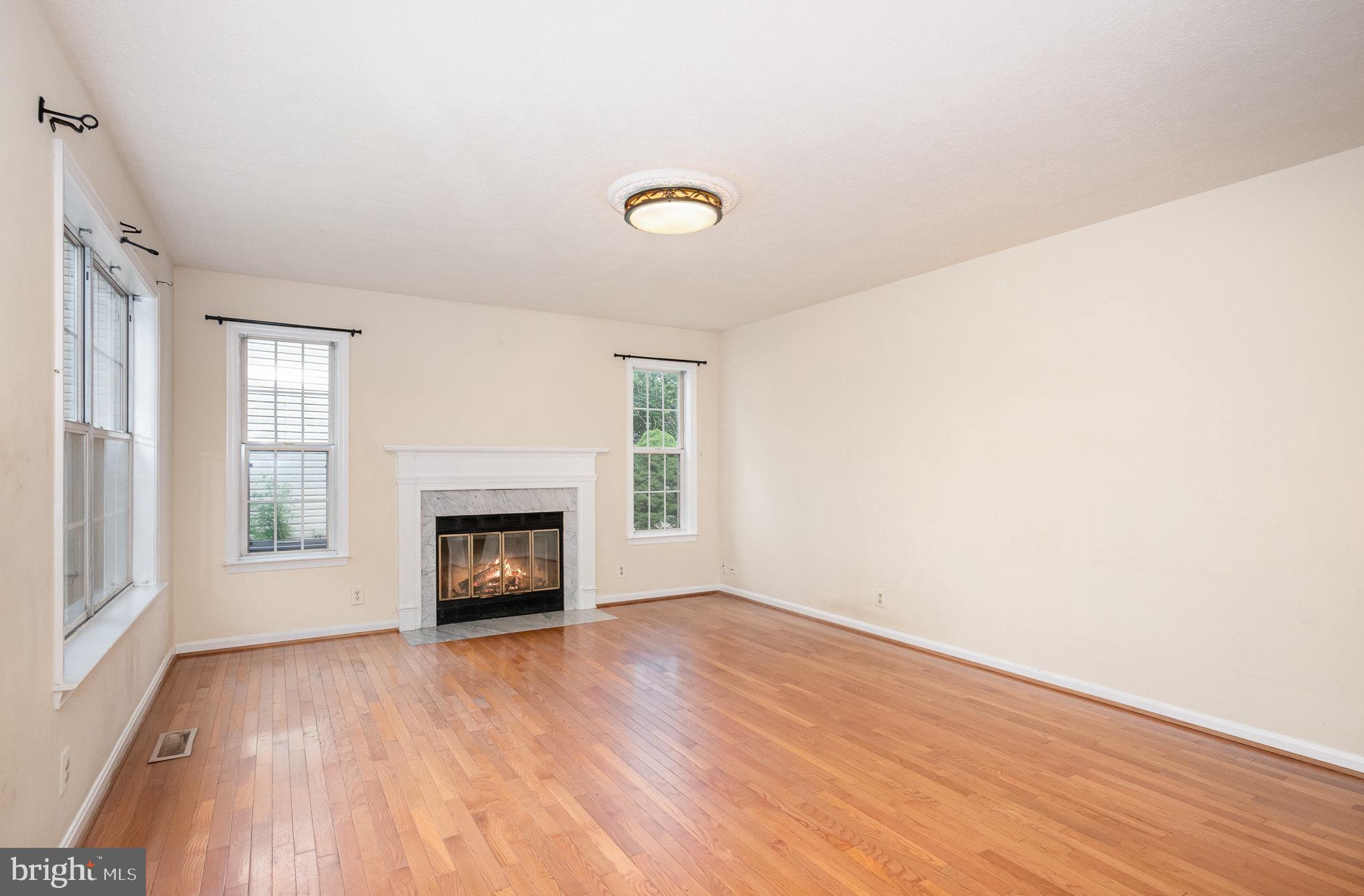 10402 Labrador Loop Manassas, VA 20112 - Photo 12 of 44 an empty room with windows and fireplace