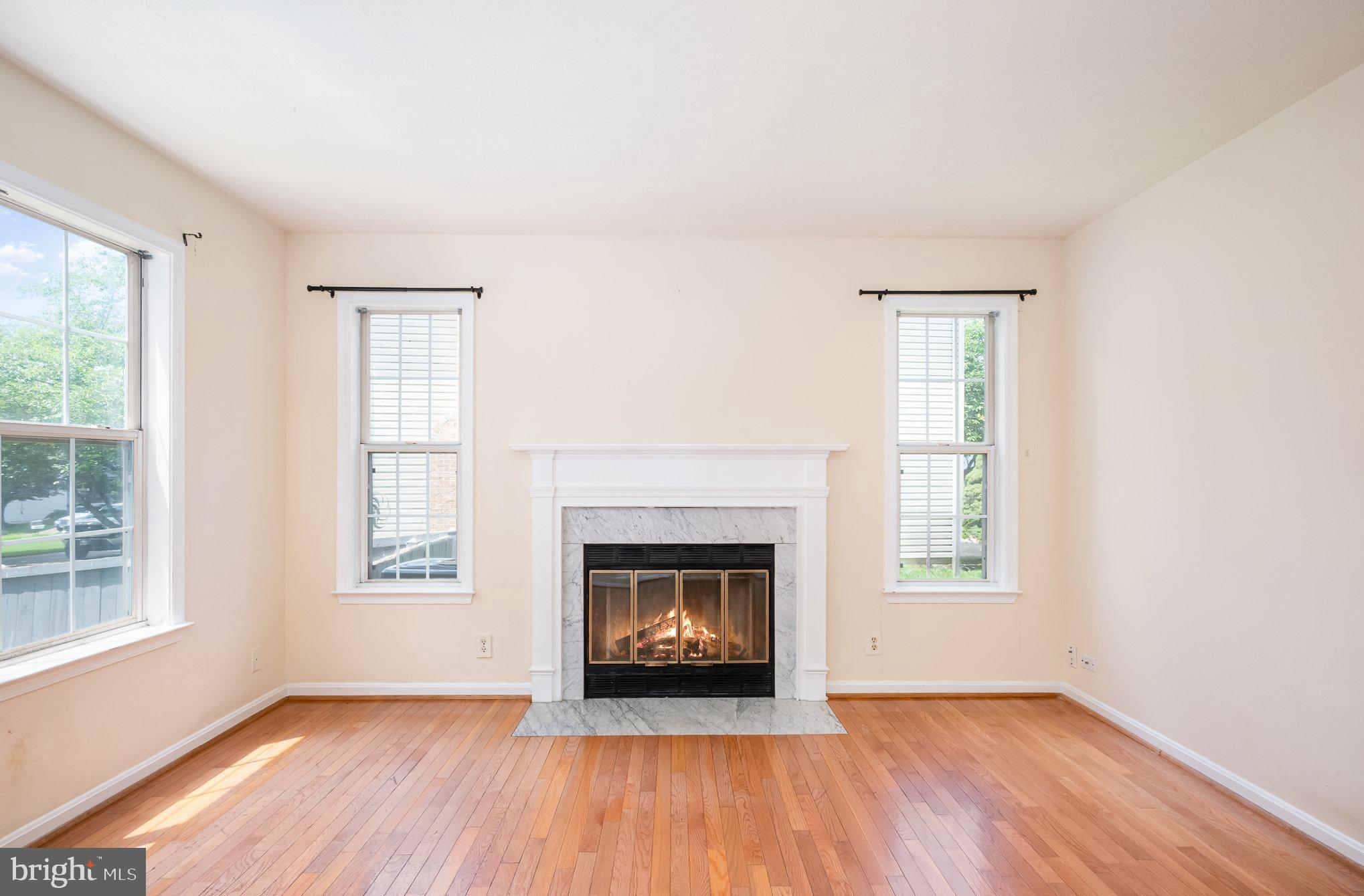 10402 Labrador Loop Manassas, VA 20112 - Photo 13 of 44 an empty room with windows and fireplace