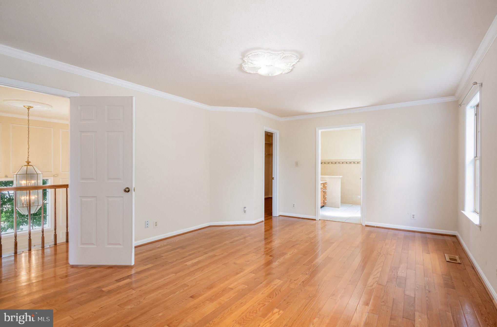10402 Labrador Loop Manassas, VA 20112 - Photo 17 of 44 an empty room with wooden floor and windows