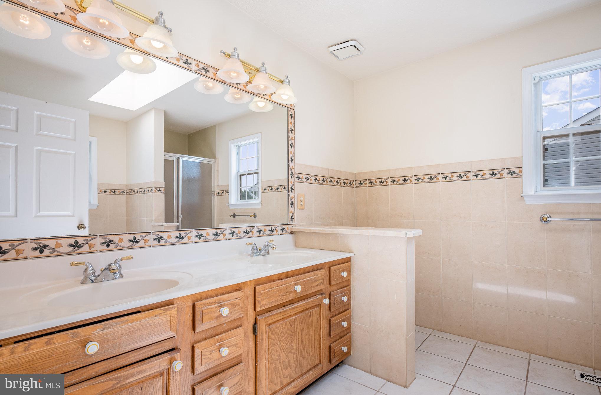 10402 Labrador Loop Manassas, VA 20112 - Photo 19 of 44 a bathroom with a sink a vanity and a mirror