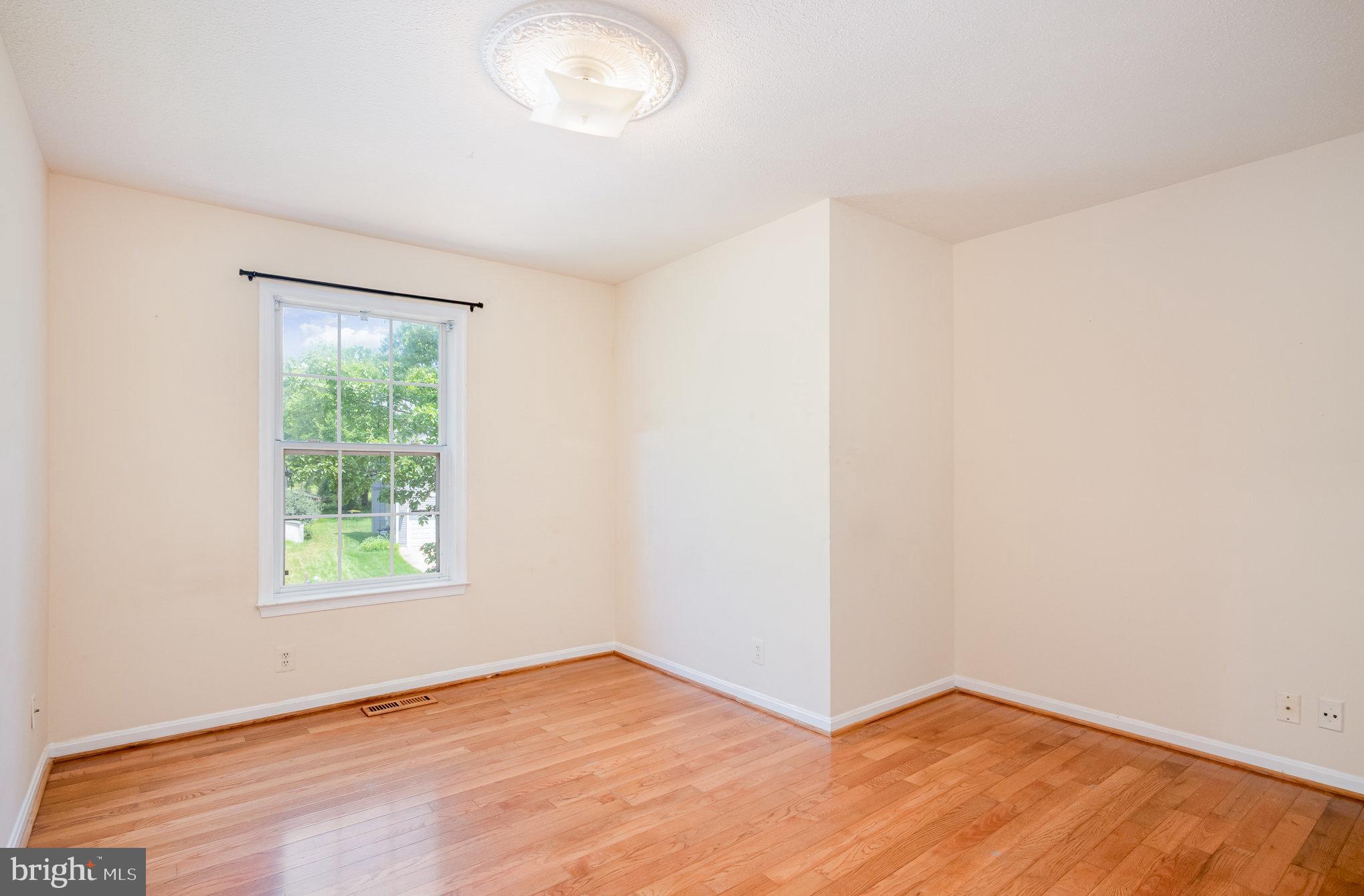10402 Labrador Loop Manassas, VA 20112 - Photo 29 of 44 an empty room with wooden floor and windows