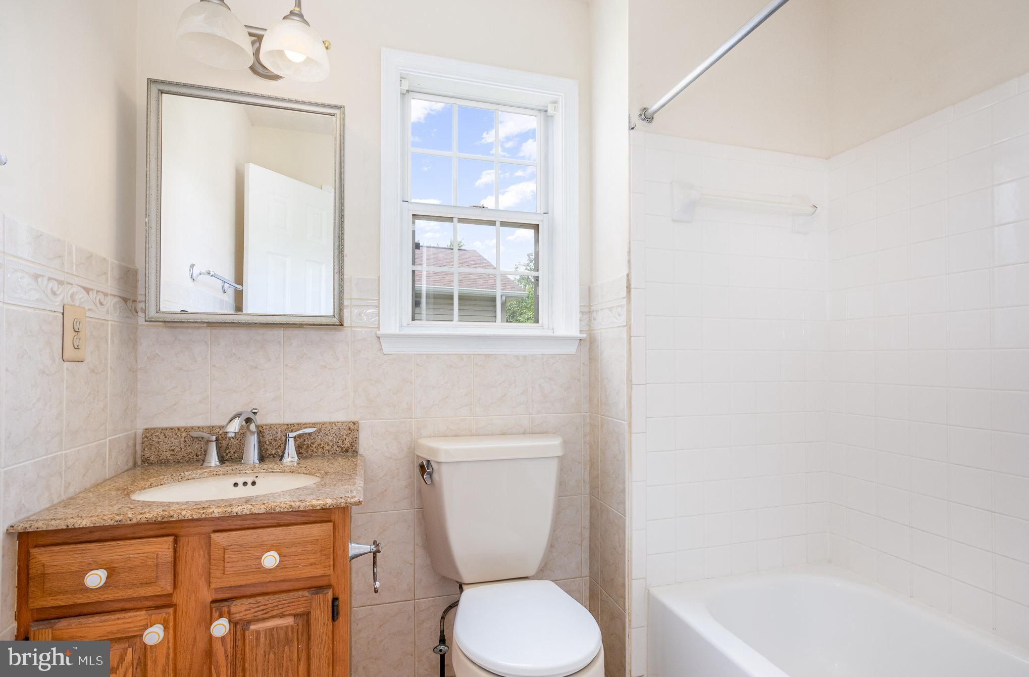 10402 Labrador Loop Manassas, VA 20112 - Photo 30 of 44 a bathroom with a granite countertop toilet sink and mirror