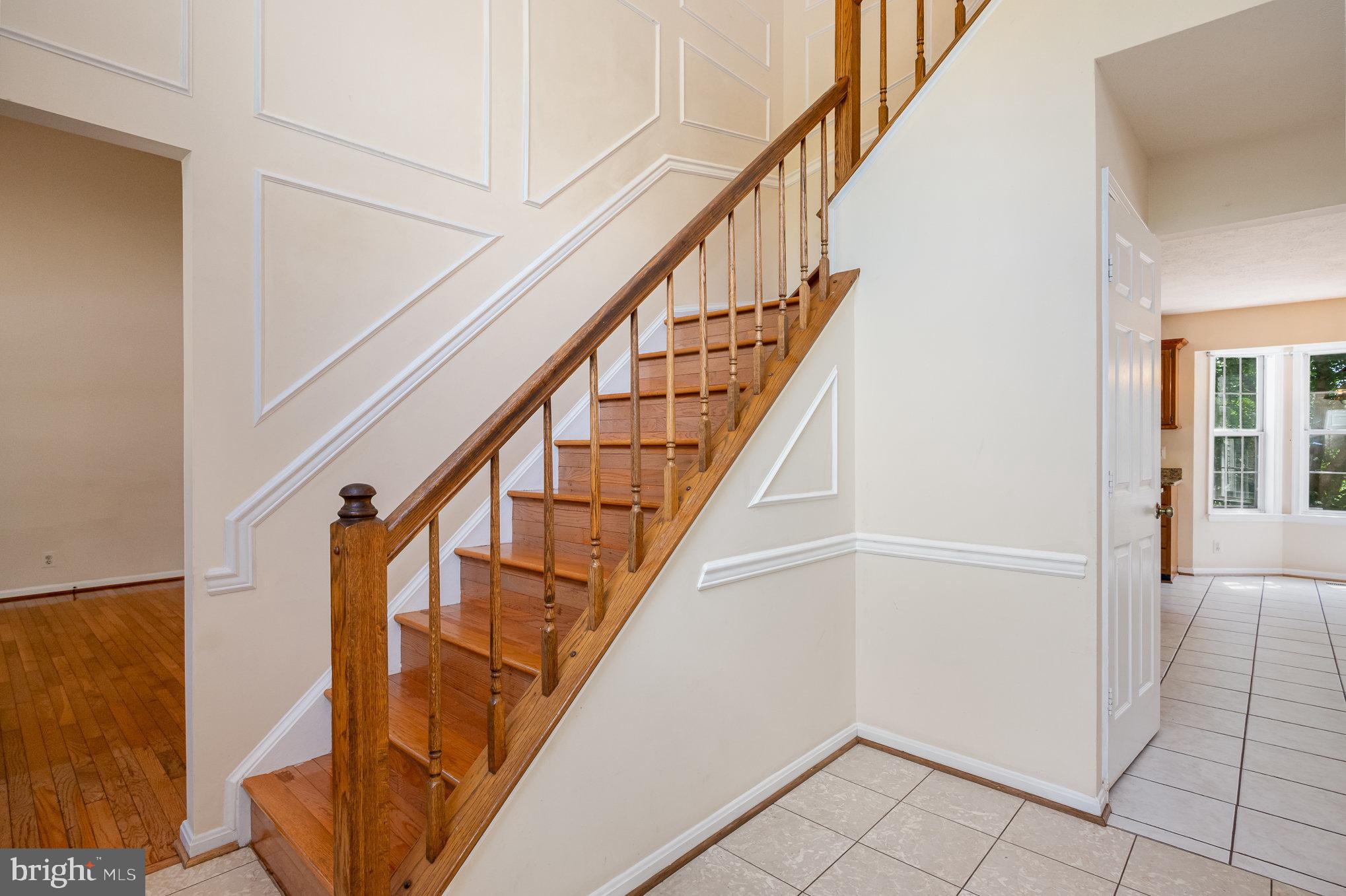 10402 Labrador Loop Manassas, VA 20112 - Photo 3 of 44 a view of entryway with wooden floor and stairs