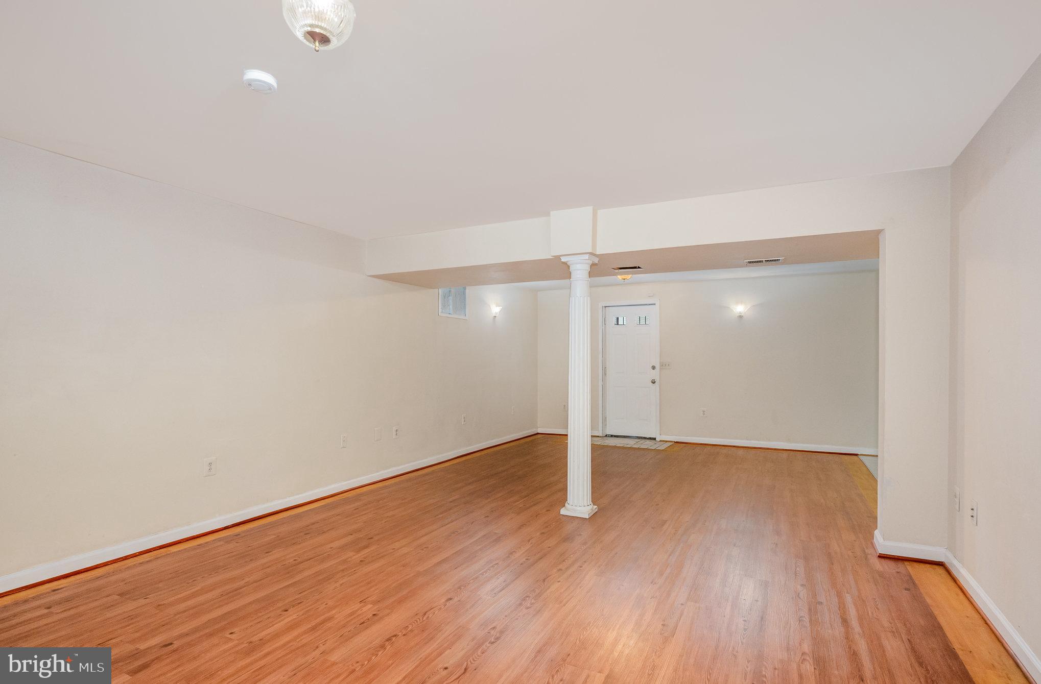 10402 Labrador Loop Manassas, VA 20112 - Photo 34 of 44 an empty room with wooden floor and windows