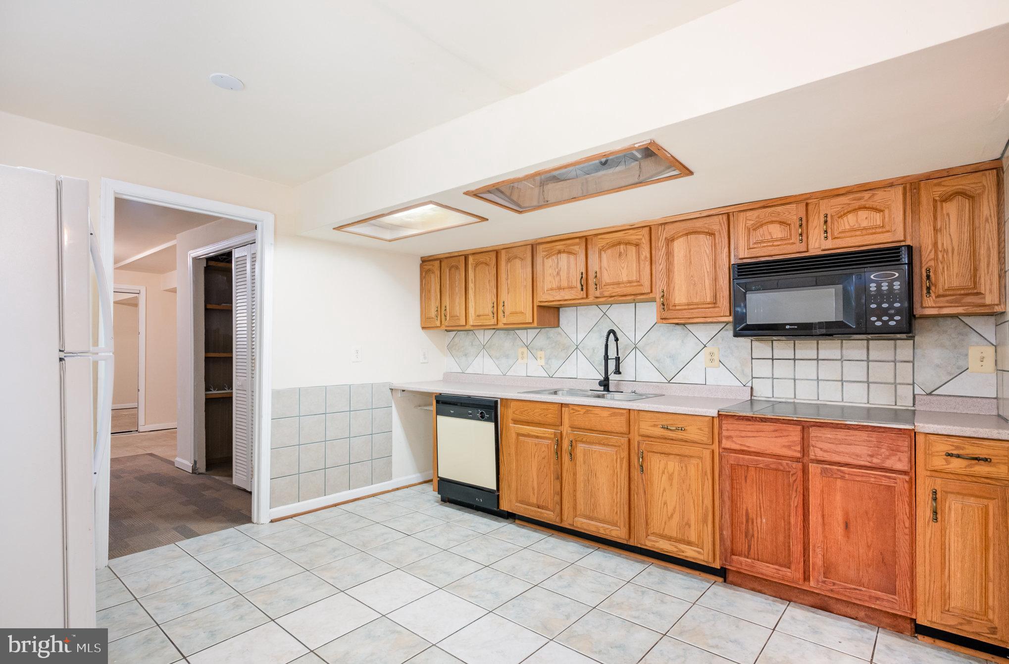 10402 Labrador Loop Manassas, VA 20112 - Photo 37 of 44 a kitchen with stainless steel appliances granite countertop a sink and a stove top oven