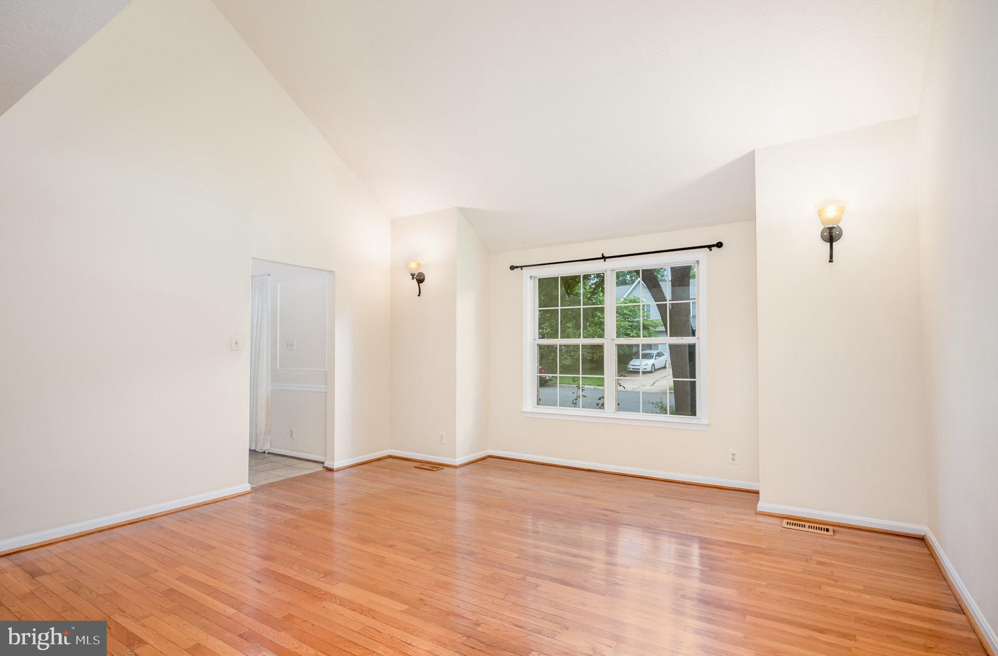 10402 Labrador Loop Manassas, VA 20112 - Photo 4 of 44 a view of an empty room with wooden floor and a window