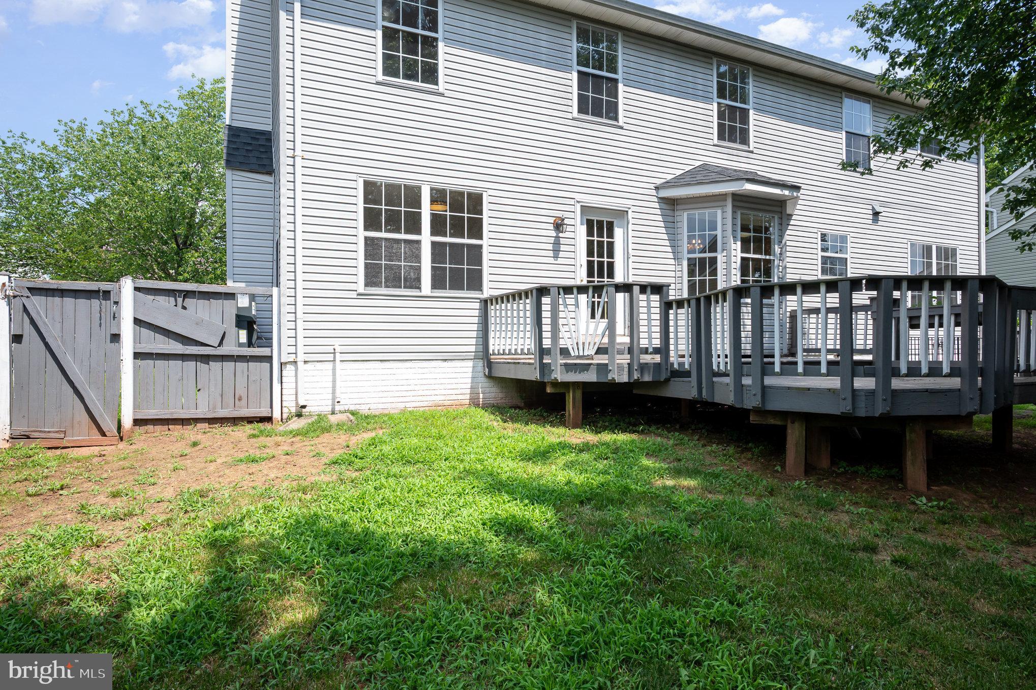 10402 Labrador Loop Manassas, VA 20112 - Photo 42 of 44 a view of a house with a backyard and wooden fence