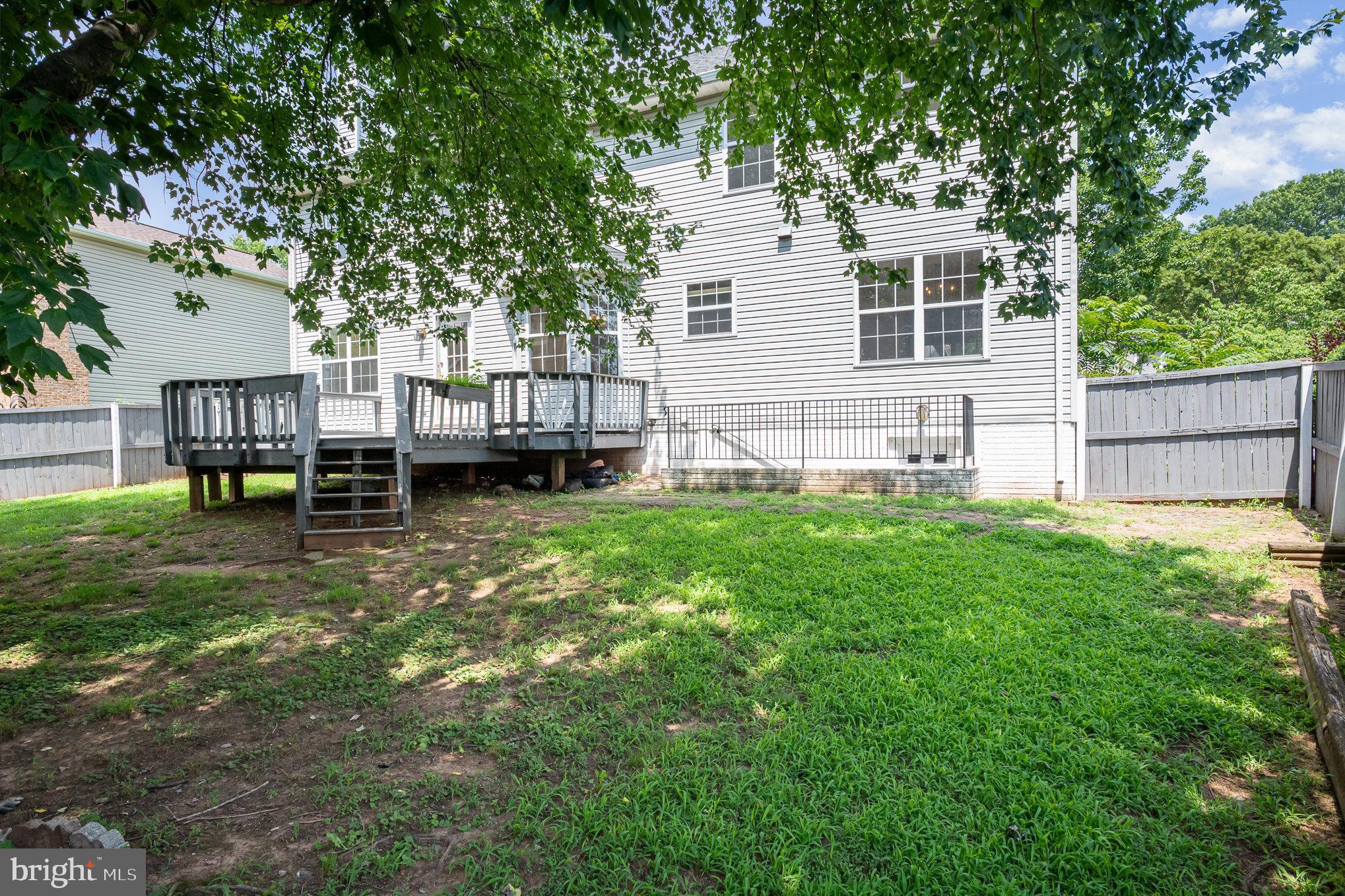 10402 Labrador Loop Manassas, VA 20112 - Photo 43 of 44 a view of a house with a backyard and a patio