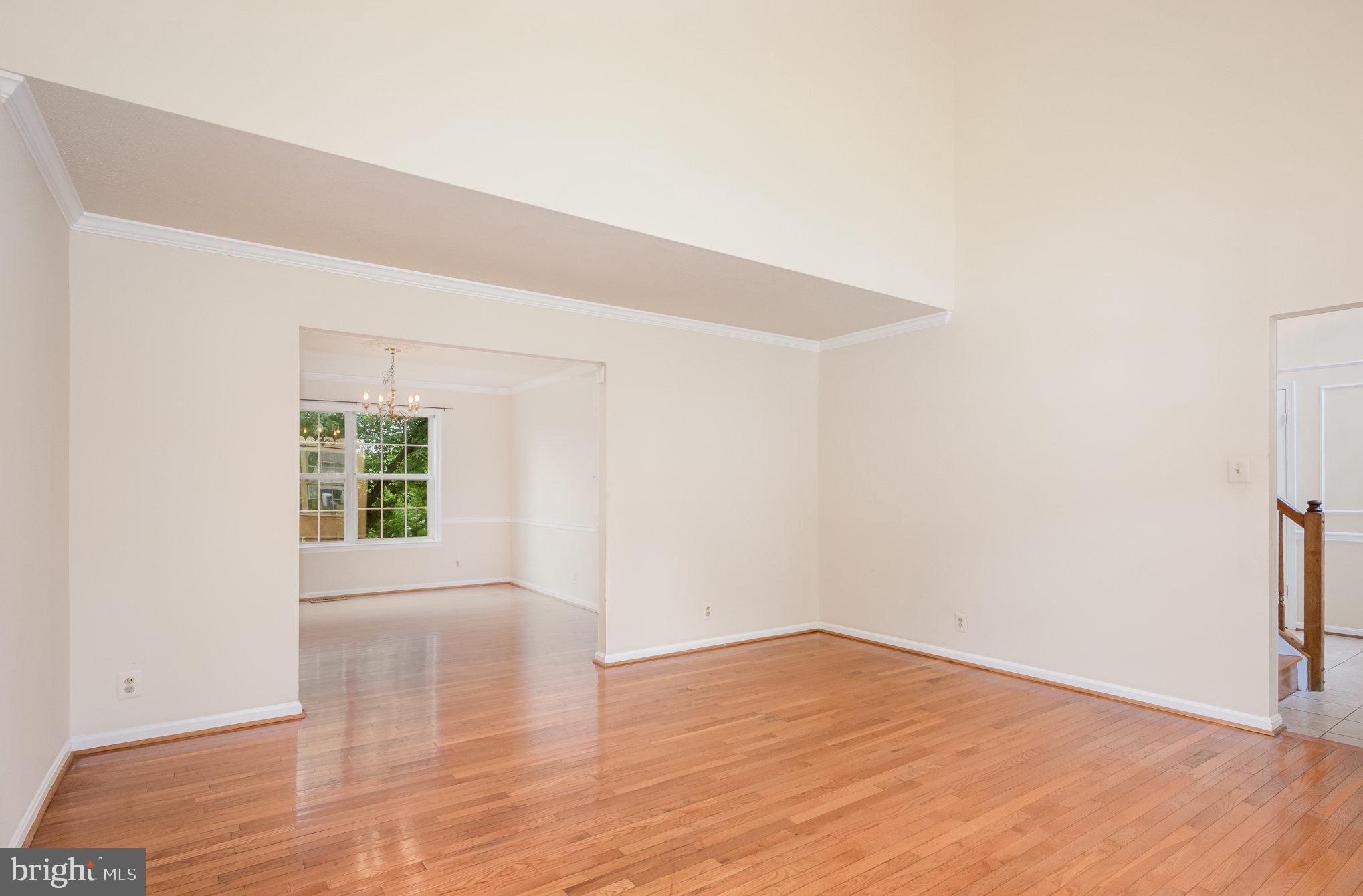 10402 Labrador Loop Manassas, VA 20112 - Photo 5 of 44 a view of an empty room with wooden floor and a window