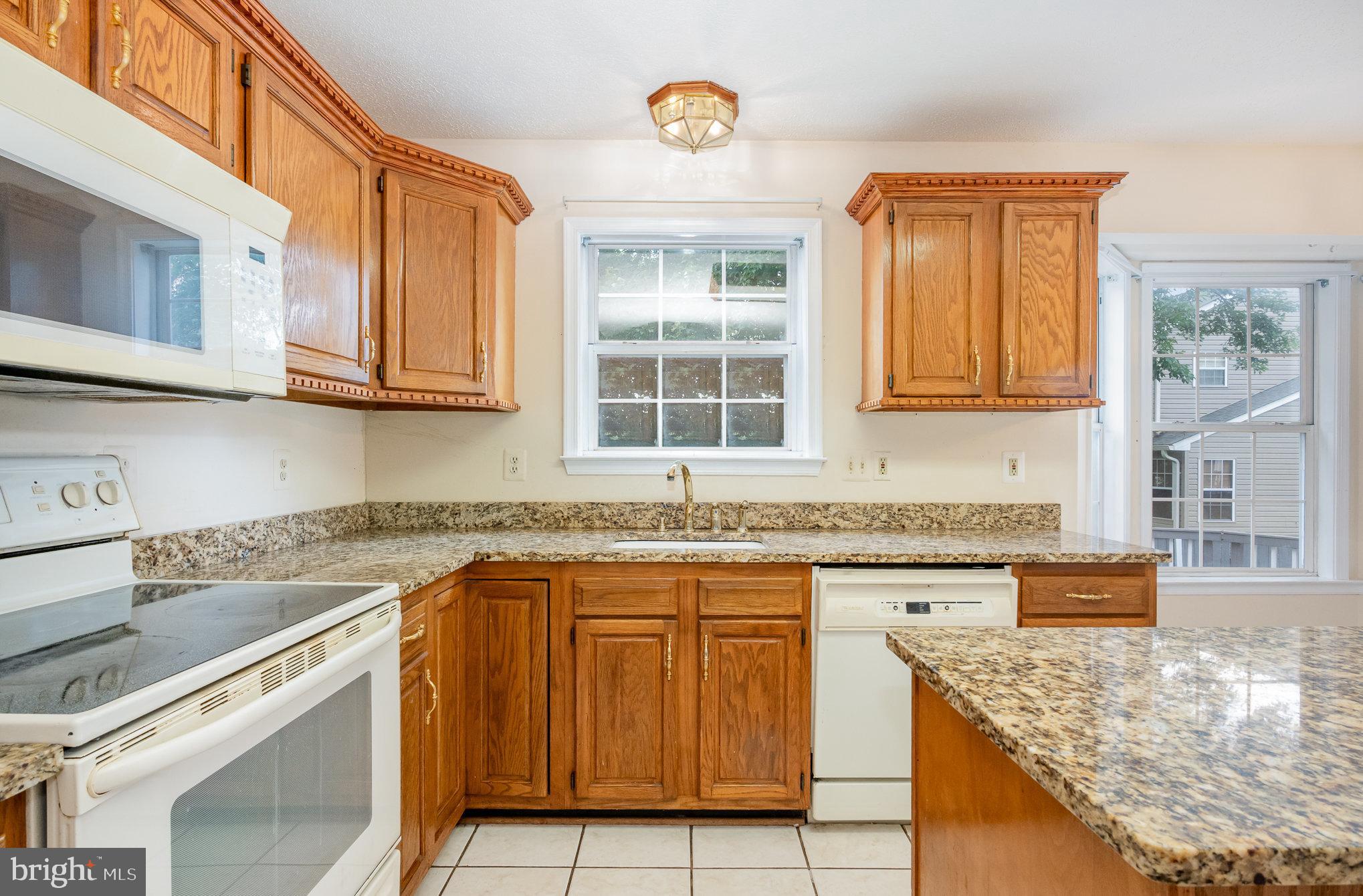 10402 Labrador Loop Manassas, VA 20112 - Photo 8 of 44 a kitchen with stainless steel appliances granite countertop a sink stove and cabinets