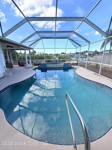 a view of a patio with a table and chairs under an umbrella