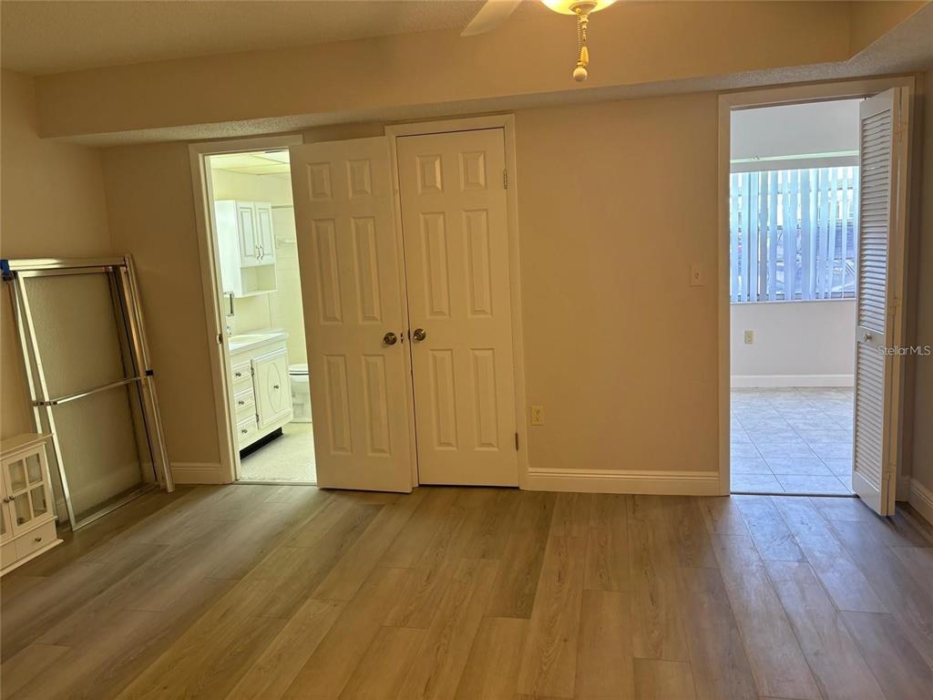 10033 64th Avenue North, Unit 1 St. Petersburg, FL 33708 - Photo 15 of 26 an empty room with wooden floor and a window