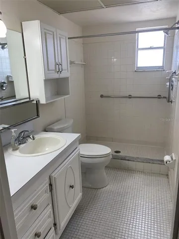 a bathroom with a sink a toilet and mirror