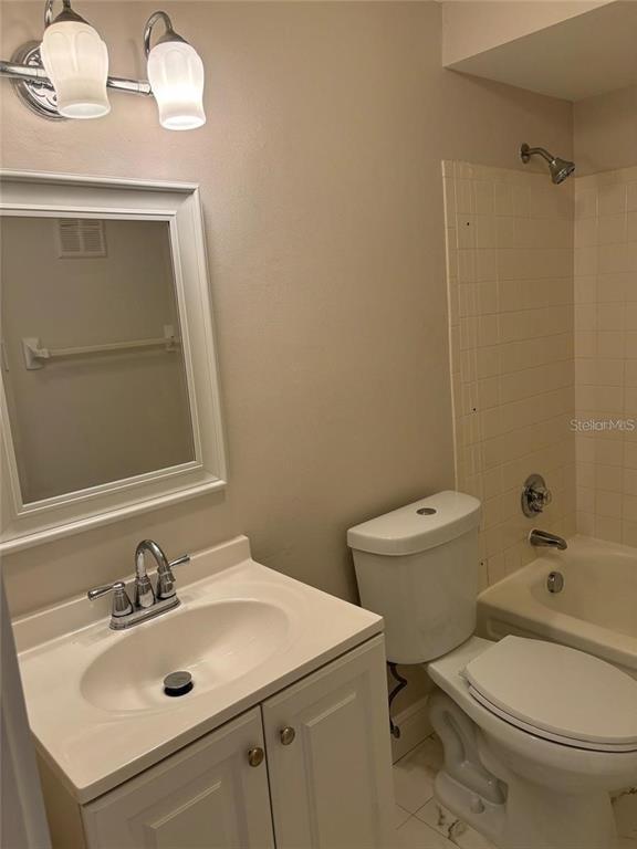 10033 64th Avenue North, Unit 1 St. Petersburg, FL 33708 - Photo 20 of 26 a bathroom with a sink a toilet and mirror