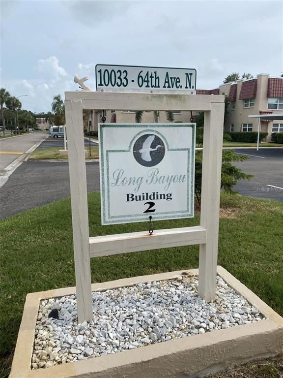 10033 64th Avenue North, Unit 1 St. Petersburg, FL 33708 - Photo 2 of 26 a sign on the side of the road