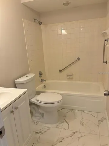a bathroom with a toilet a sink and a shower