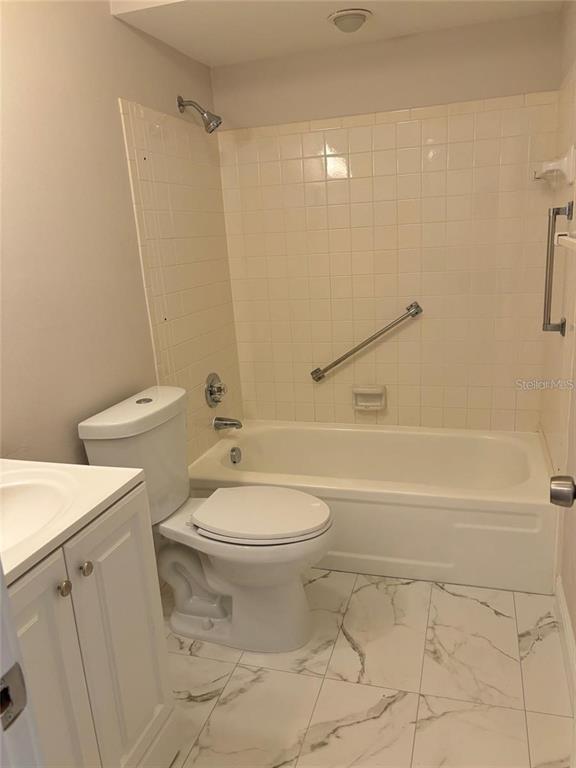 10033 64th Avenue North, Unit 1 St. Petersburg, FL 33708 - Photo 21 of 26 a bathroom with a toilet a sink and a shower