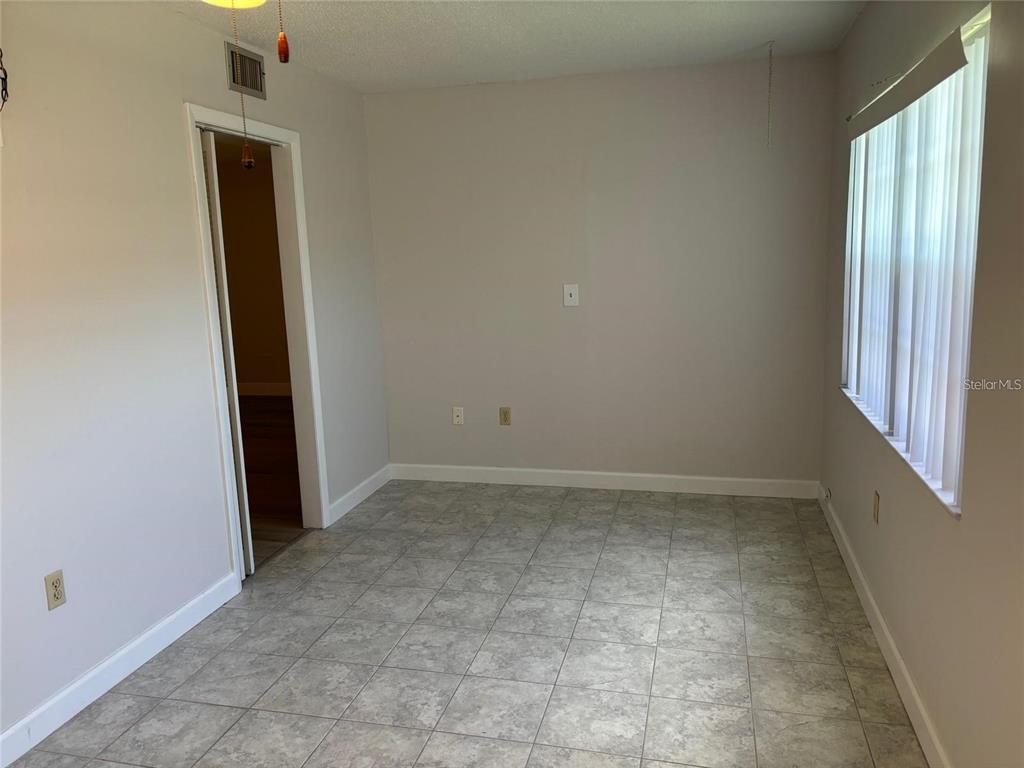 10033 64th Avenue North, Unit 1 St. Petersburg, FL 33708 - Photo 10 of 26 an empty room with windows
