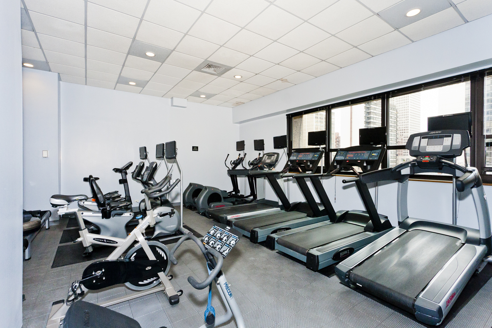 1030 North State Street, Unit 23F Chicago, IL 60610 - Photo 11 of 13 a room with gym equipment and large mirror