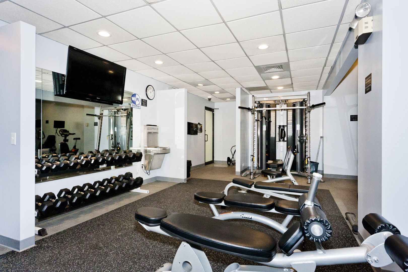 1030 North State Street, Unit 23F Chicago, IL 60610 - Photo 12 of 13 a room with gym equipment and a large window