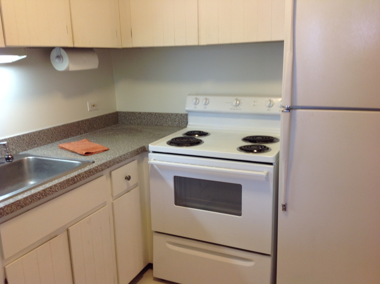 1030 North State Street, Unit 23F Chicago, IL 60610 - Photo 5 of 13 a kitchen with white cabinets and white appliances