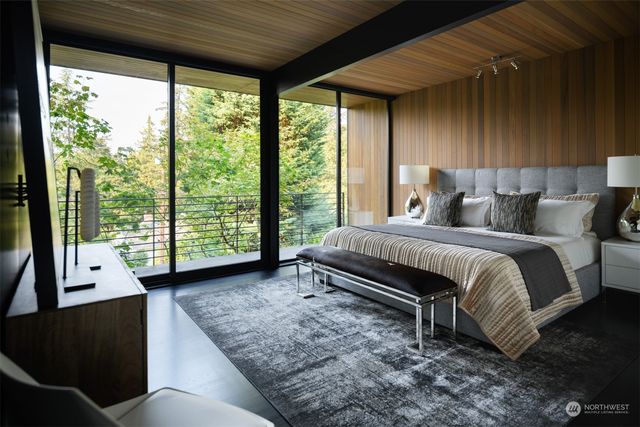 a bedroom with a large bed and a large window