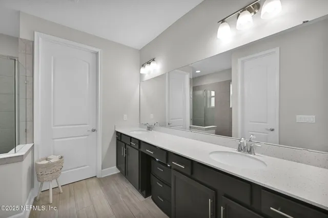 a spacious bathroom with a double vanity sink and a mirror