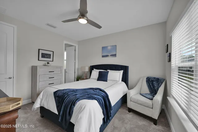 a bedroom with a bed and a couch