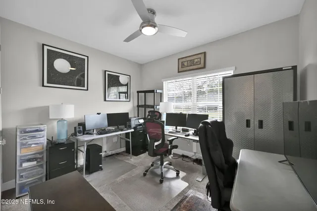 a view of a workspace with furniture and a window