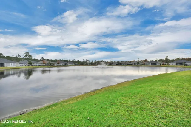 a view of a lake with houses in the back