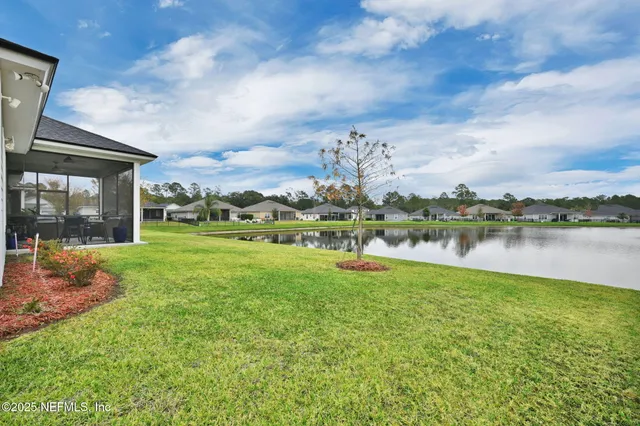a view of a lake with houses in the back