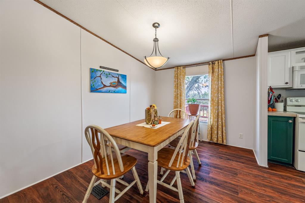 192 Big Salty Lane Springtown, TX 76082 - Photo 11 of 36 a view of a dining room with furniture window and wooden floor