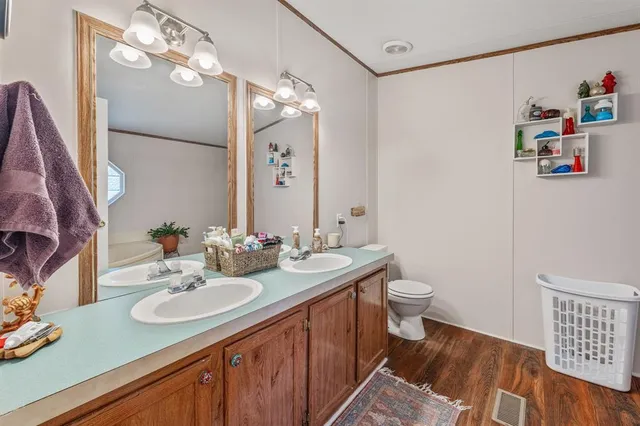 a bathroom with a sink vanity granite and toilet