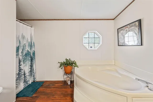 a bathroom with a tub and shower